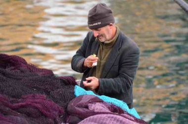 Cruising the Bosphorus A fisherman at Anadolu Kavagi works on his net.