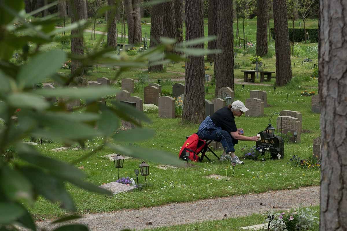 Sweden Skogskyrkogarden tending to a loved one