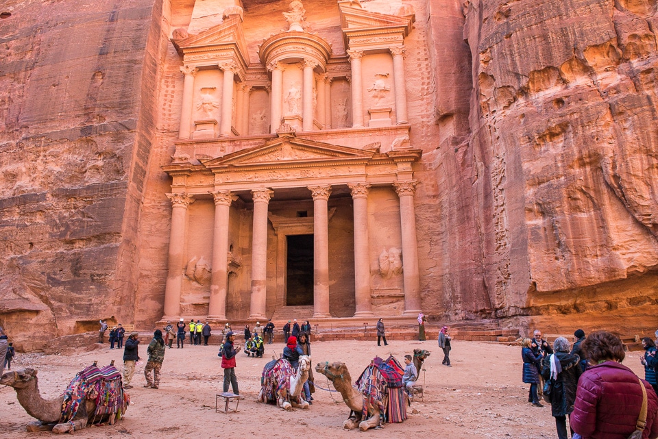 tourists camels treasury petra jordan