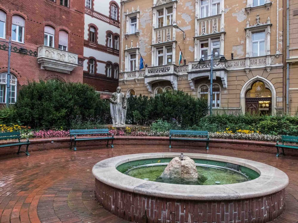 Kalman Mikszath square. That's a statue of Mikszath in the middle. He was a Hungarian writer who took special note of the foibles and hypocrisy of the aristocrats who lived in the Palace District. Obviously his statue and square was not funded by his subjects.