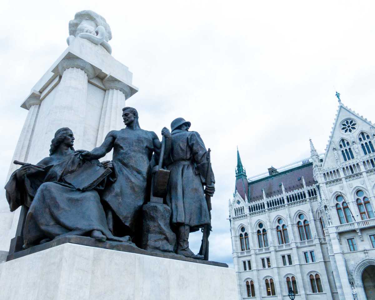 A bleak statue recalling Soviet times presses up against the Parliament building.