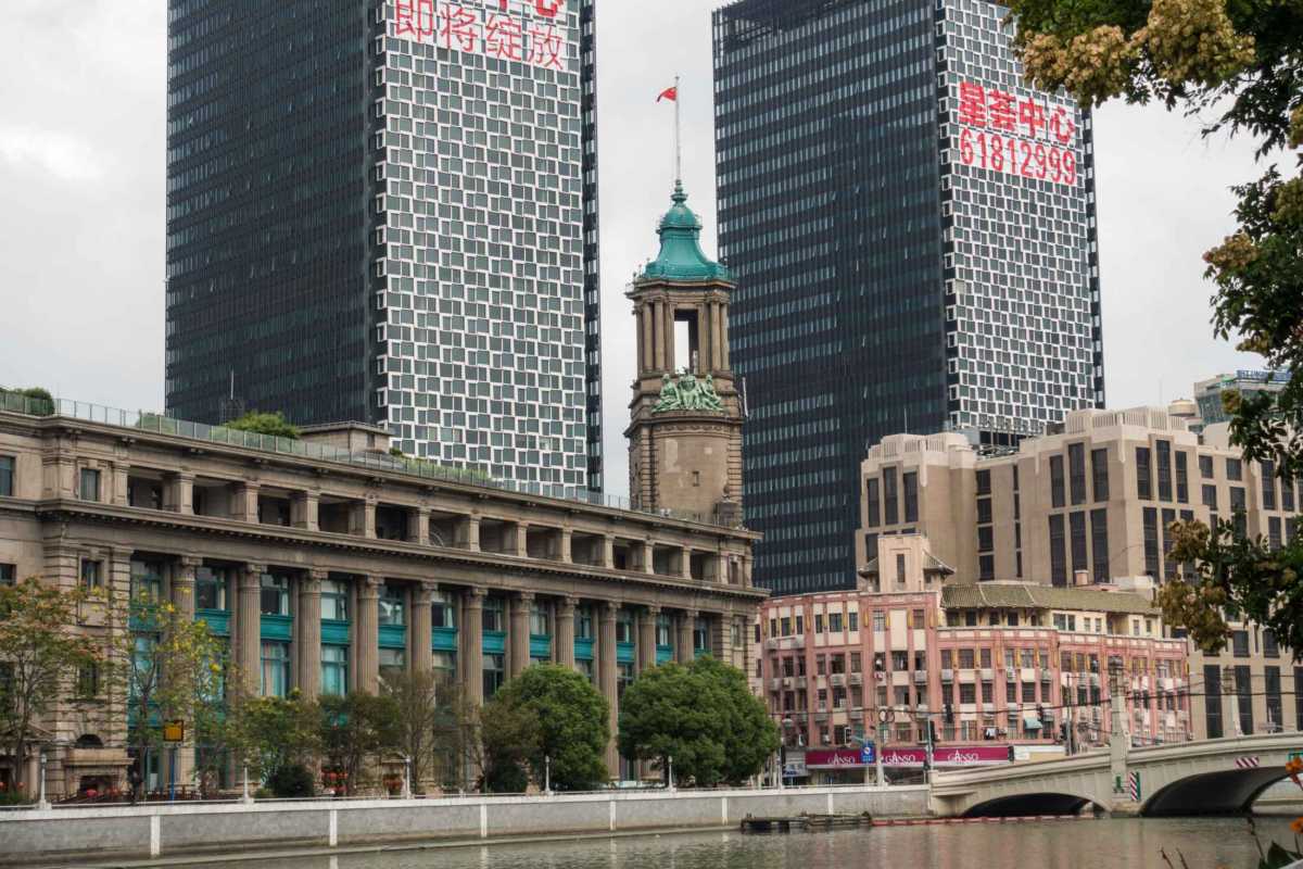Newer buildings loom over a neoclassic edifice along the Bund in Shanghai