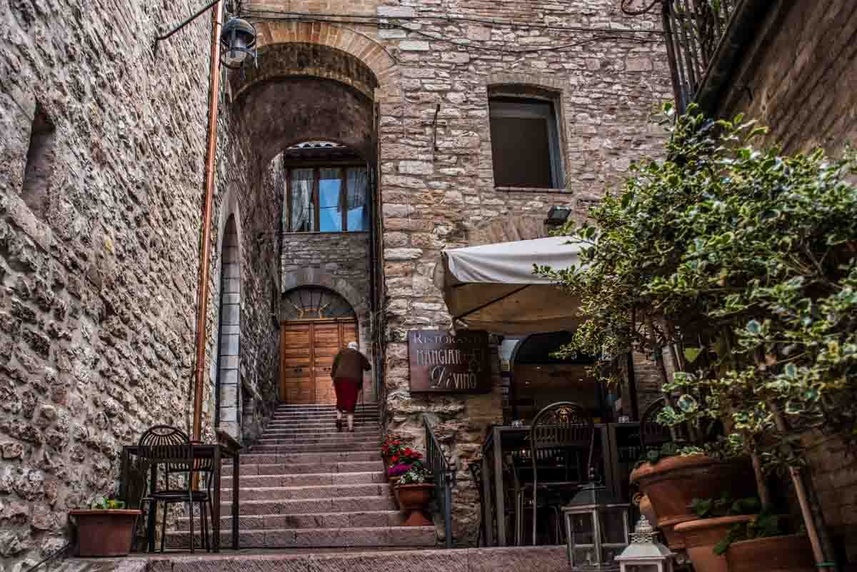 italy assisi woman walking up stairs