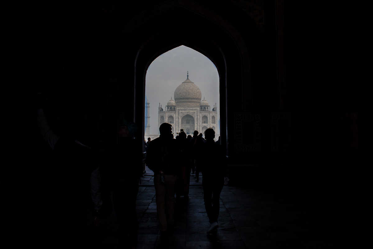 india photographing taj mahal first view archway
