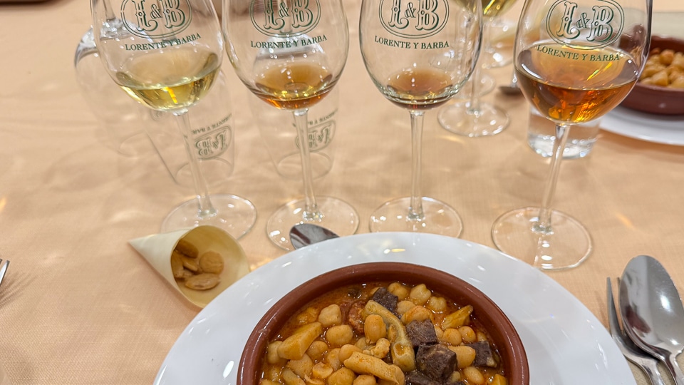 Sherry tasting flight at Viña Lorente y Barba showing fino with almonds amontillado with cheese oloroso with jamón and palo cortado with garbanzo stew