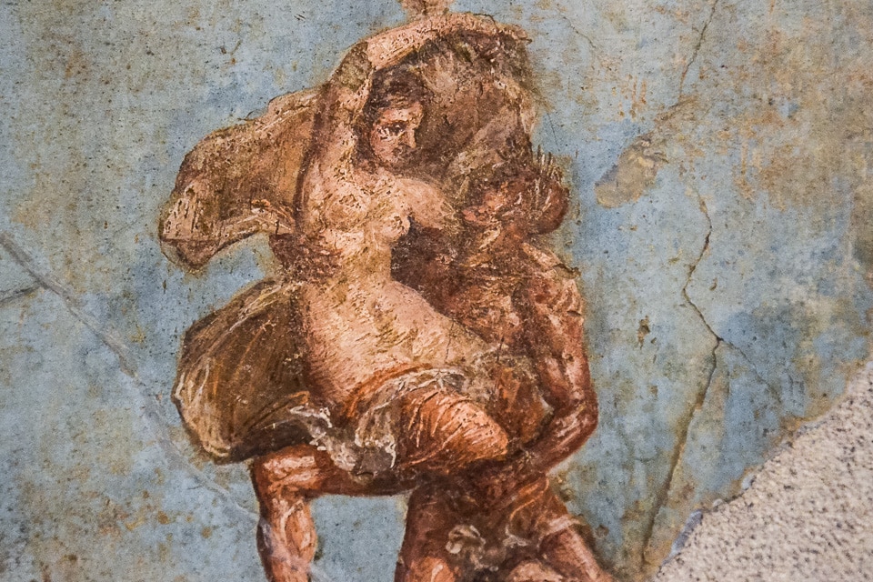 A satyr and a maenad in flight found in the House of the Dioscuri in Pompeii. It is currently housed in the National Archaeological Museum of Naples.
