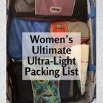 Open carry-on roller bag neatly organized with eBags and Eagle Creek packing cubes — women's ultimate ultralight packing list for travelers over 50 from TravelPast50.com.