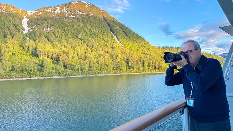 Stateroom balcony aboard the American Constitution with sliding glass doors and outdoor seating for wildlife viewing