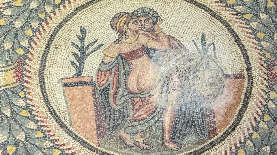 Round mosaic medallion of a couple kissing, the woman seen from behind with her robe slipping off, Villa Romana del Casale