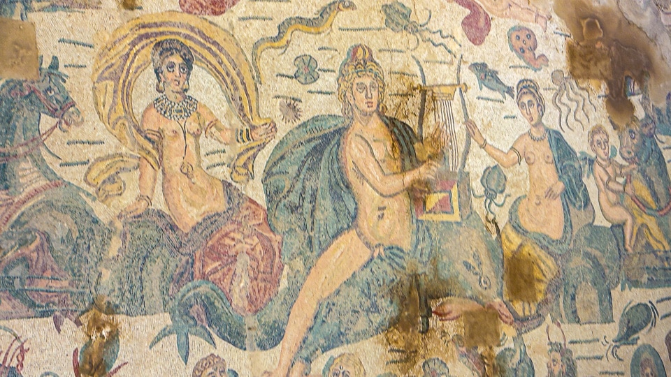 Arion playing a lyre while riding a dolphin, surrounded by sea nymphs on sea creatures, mosaic at the Villa Romana del Casale